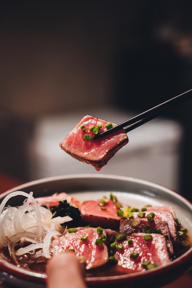 Slices of tuna sashimi served in a bowl.