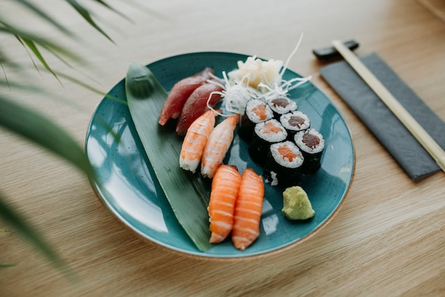 An assortment of sushi served on a ceramic plate.