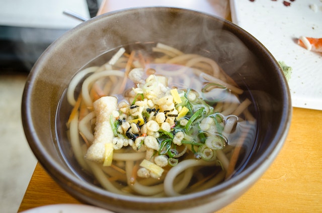 A bowl of steaming hot udon noodles.